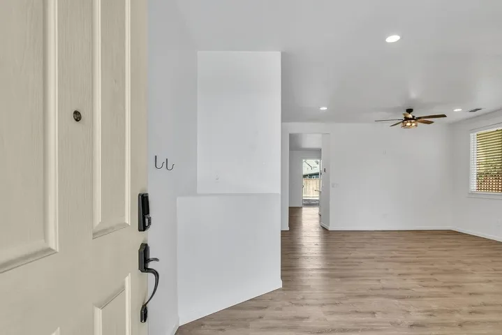 Entryway featuring recessed lighting, healthy amount of natural light, light wood-style floors, and a ceiling fan