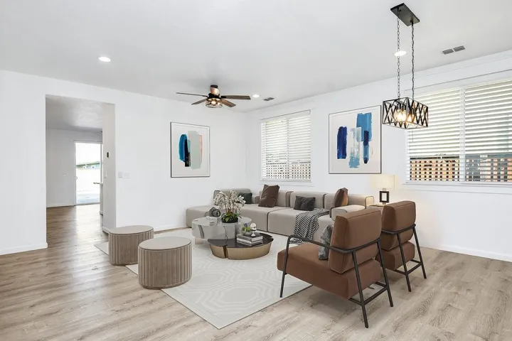 Living room featuring light wood-style floors, recessed lighting, and a ceiling fan
