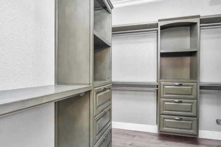 Spacious closet with light wood-style flooring