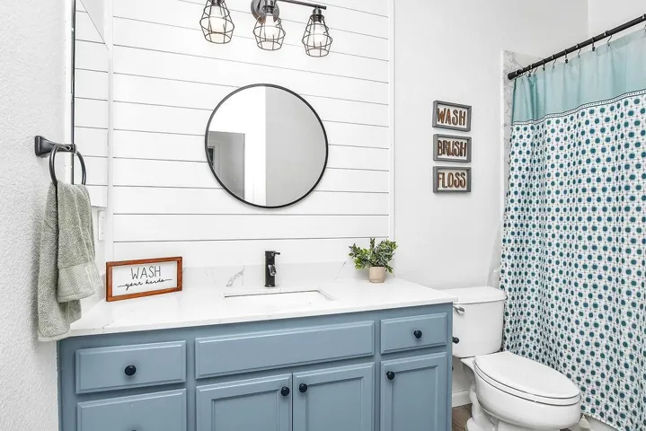 Bathroom with vanity and curtained shower