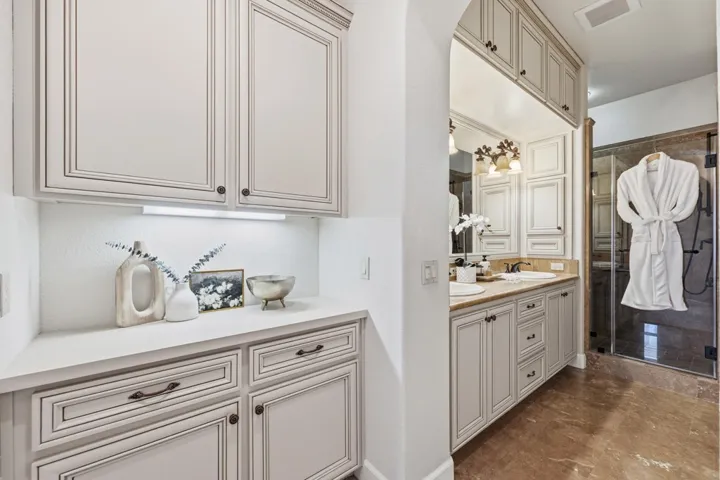 Bathroom featuring double vanity and a shower stall