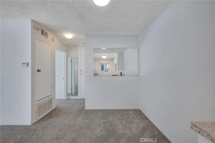 Dining, leading to primary bedroom and bathroom, not staged