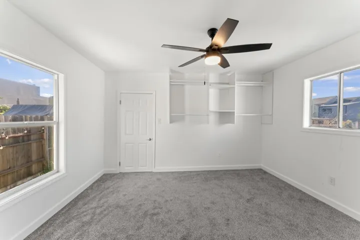 Unfurnished bedroom featuring carpet and a ceiling fan