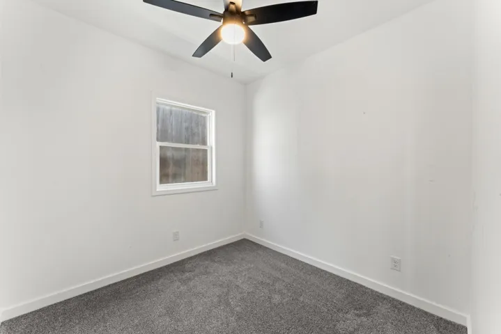 Spare room with carpet flooring and a ceiling fan