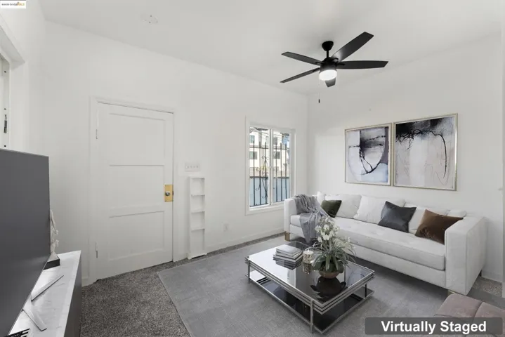 Living room featuring dark carpet and ceiling fan
