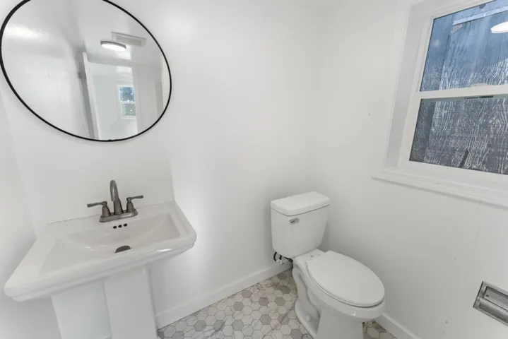 Bathroom featuring baseboards and toilet