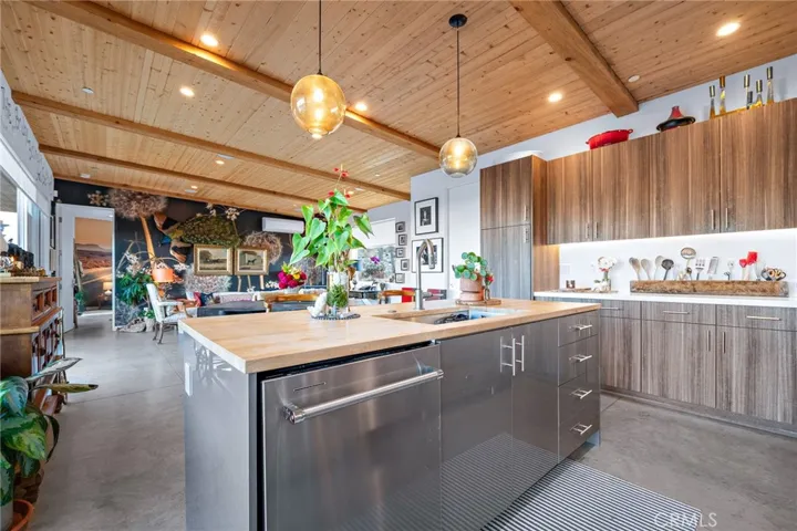 Kitchen with custom cabinets, wood ceiling ,recessed lighting and pendant lighting