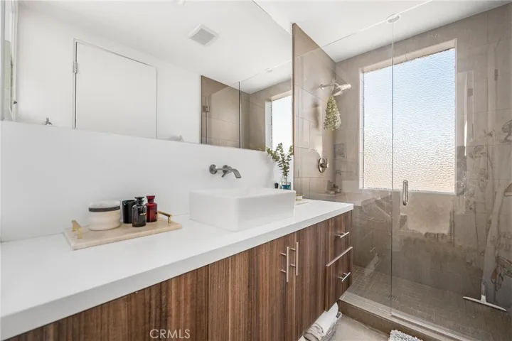 Primary suite #1 bathroom with rain shower and frosted window for natural lighting with privacy