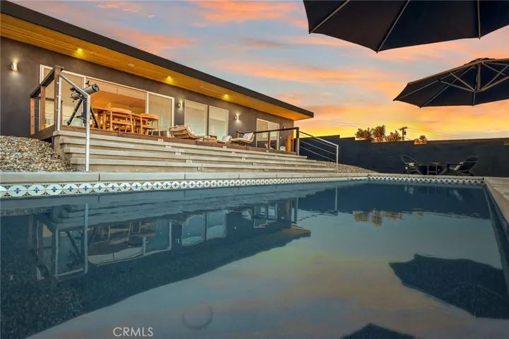 Exterior with deck, custom salt water pool, spa and outdoor shower