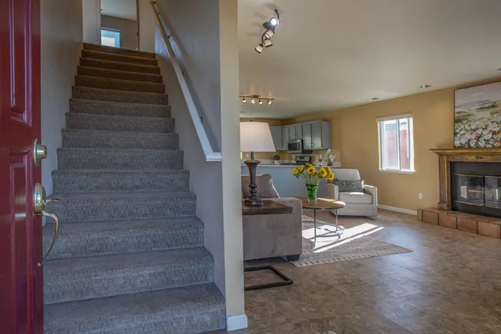 Welcoming spacious entry way with warm color pallet. Carpeted stairs carry's through upstairs rooms.