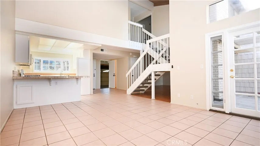 VIEW OF MAIN ENTRY, KITCHEN AND DINING AREA