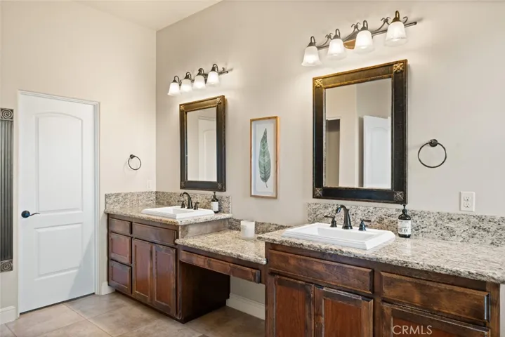 Large granite vanity with dual sinks and walk-in closet