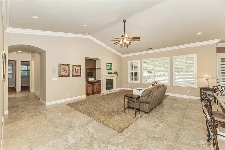 Great Room with vaulted ceiling and crown moulding