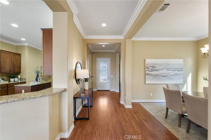 Entry with view of kitchen and dining room with wood floors