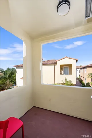 Balcony overlooks community water feature and fireplace.