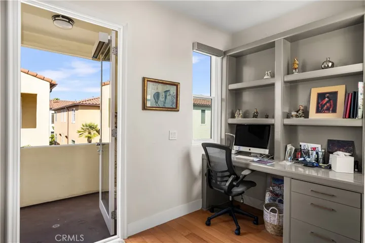 Built-in desk area with door to view balcony.