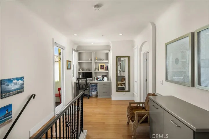 Upstairs landing features cabinets and built-in desk.
