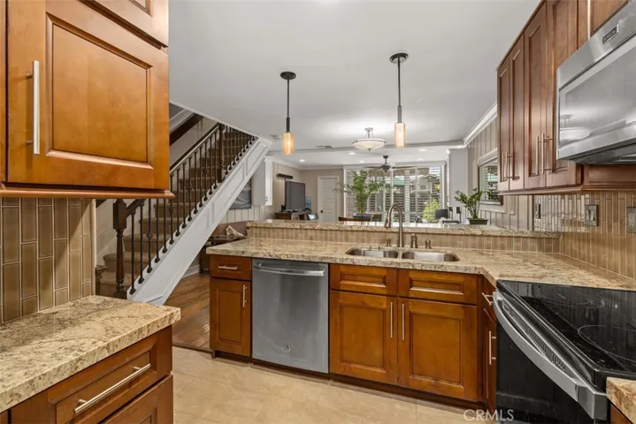 Rich wood cabinets with stainless appliances. 
Photos from pre-tenant occupancy (2023)