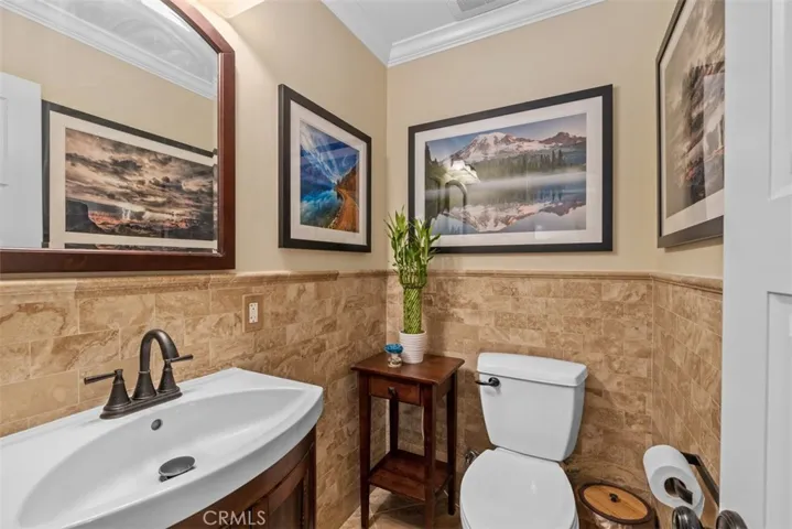 Main level half bathroom surrounded with tile walls.
Photos from pre-tenant occupancy (2023)