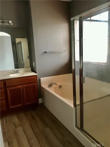 Master's Bathroom with Bath tub, Vanity area, Walk-in Shower, and separate toilet