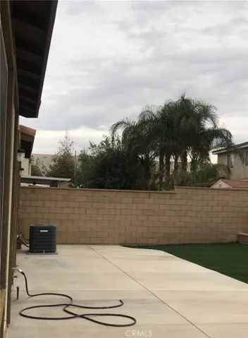 Backyard concrete, concrete block fence walls, 3 sides