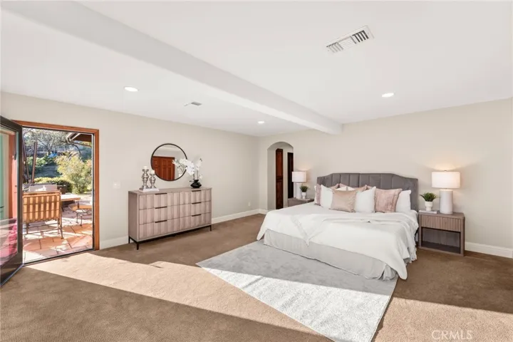 Primary Bedroom with walkout to deck overlooking the arena