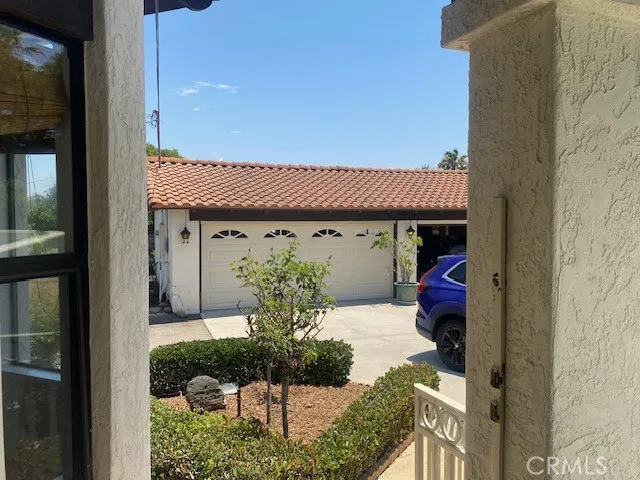 View from front door looking to 3 car garage structure
