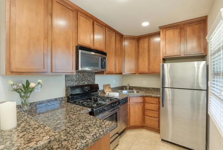 Granite countertops, built-in microwave, and stainless steel appliances