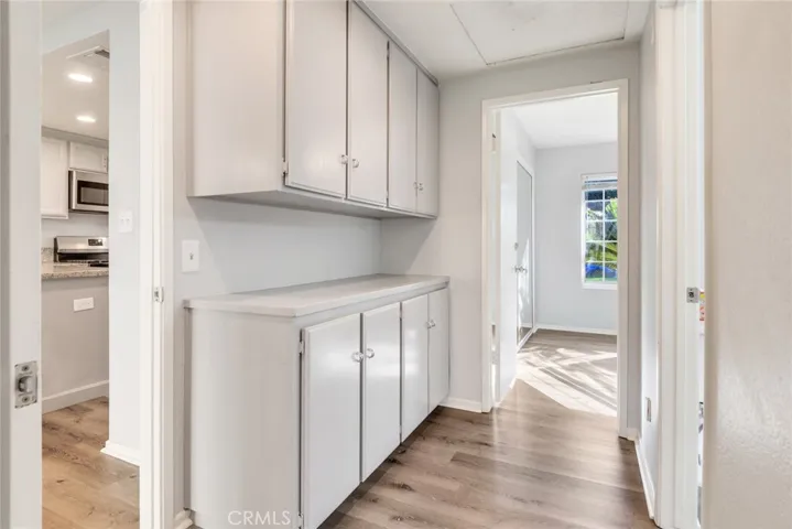 Hallway between the two additional bedrooms with ample storage space.