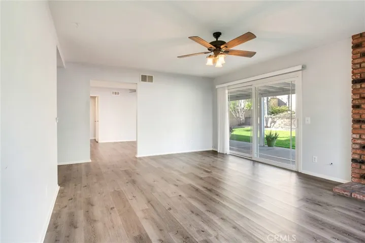 Living room with a view into the kitchen/dining area