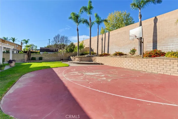 The backyard is an entertainer's dream featuring a covered patio with sports court and plenty of space for BBQs and parties.