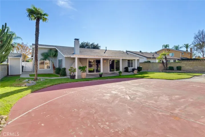 The backyard is an entertainer's dream featuring a covered patio with sports court and plenty of space for BBQs and parties.
