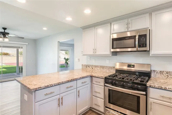 The kitchen/dining area features direct views into the beautiful backyard.