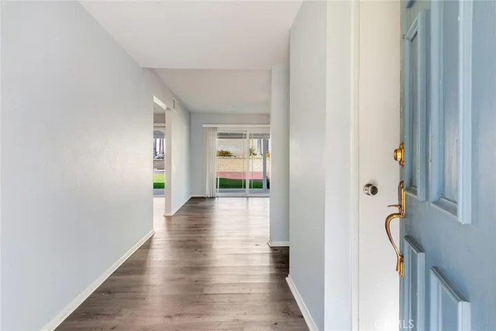 Welcome home! The entryway features a direct view to the backyard. Wood laminate floors are featured throughout the home.