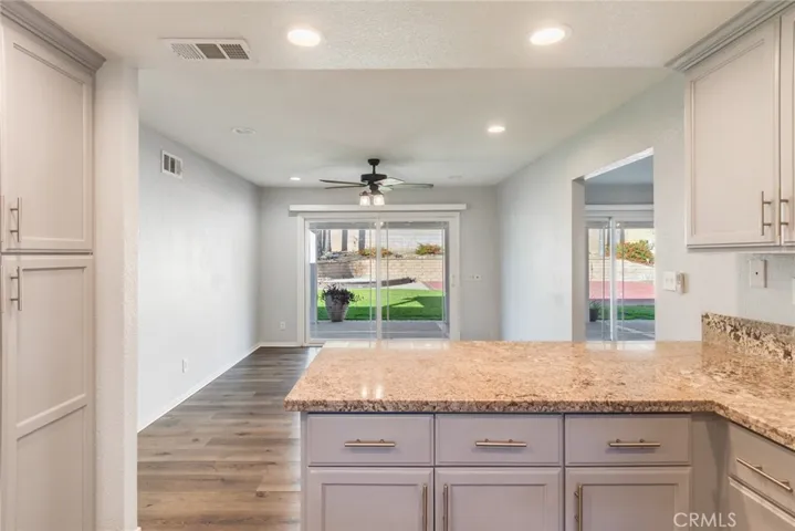The kitchen/dining area features direct views into the beautiful backyard.