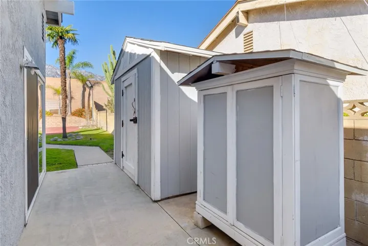 Side yard with storage and access to the primary bedroom