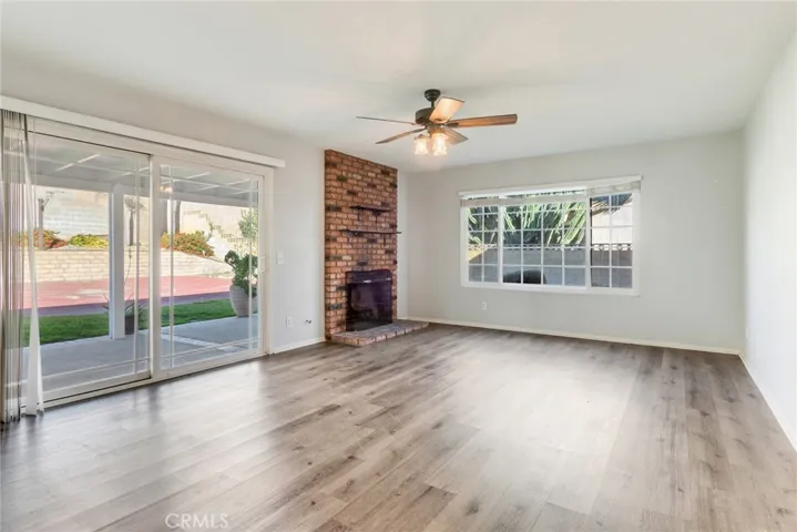 Enjoy cozy nights in this living room with the beautiful, brick, gas fireplace as well as easy access to the backyard.