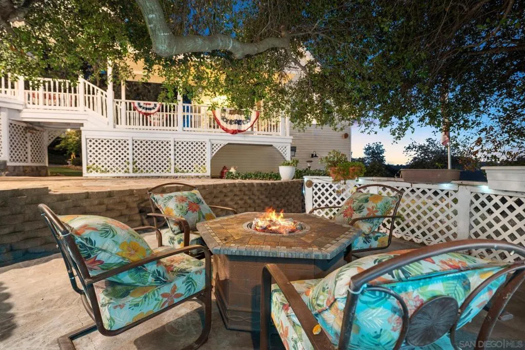 Comfortable patio with firepit beneath the canopy of a large old oak tree.