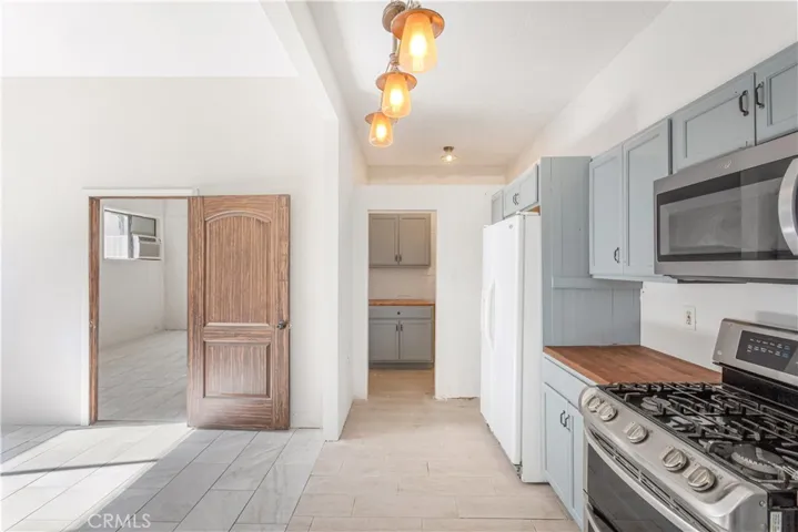 Casita kitchen with laundry room straight ahead and bedroom to the left through the door.