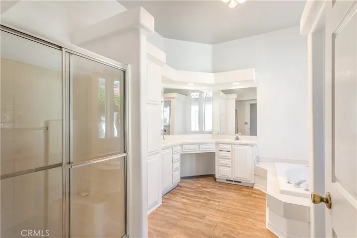 Primary bath has separate shower and soaking tub.