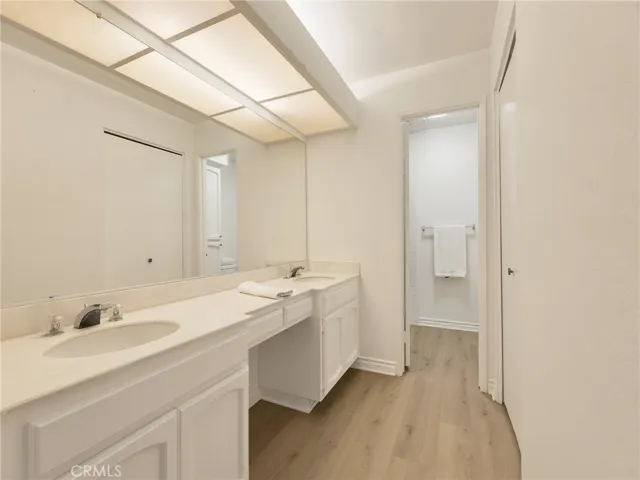 Primary suite has double sinks and dressing area.