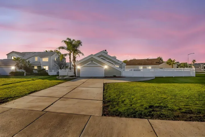 View of front of home with concrete driveway and stucco siding