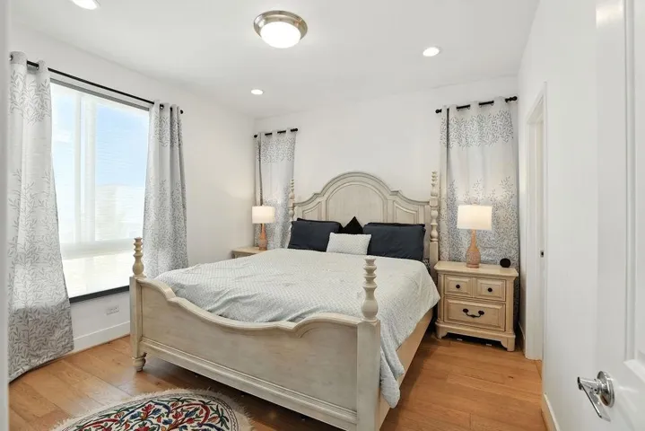 Bedroom with light wood-style flooring and recessed lighting