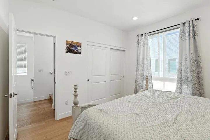 Bedroom featuring light wood-style flooring, a closet, and recessed lighting