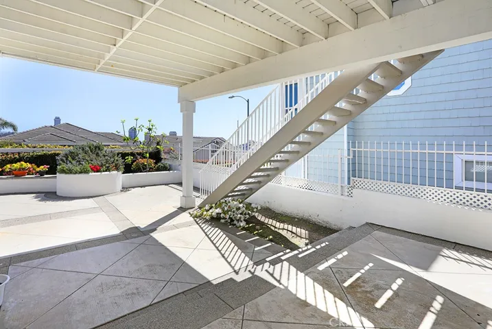 Stairs from patio up to the deck