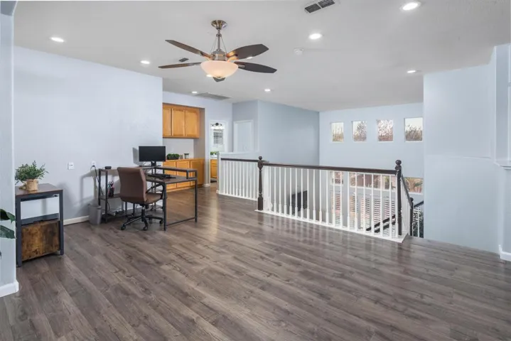 Office with recessed lighting, dark wood-style floors, and a ceiling fan