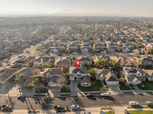 Aerial view of property's location with a mountain backdrop