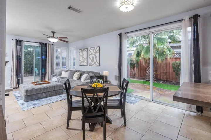 Dining room featuring ceiling fan and light tile patterned flooring