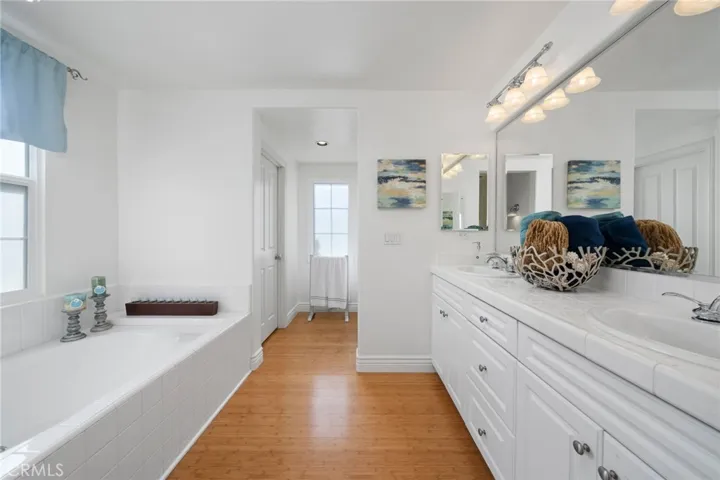 Luxurious primary bathroom with lovely bathtub to relax in.