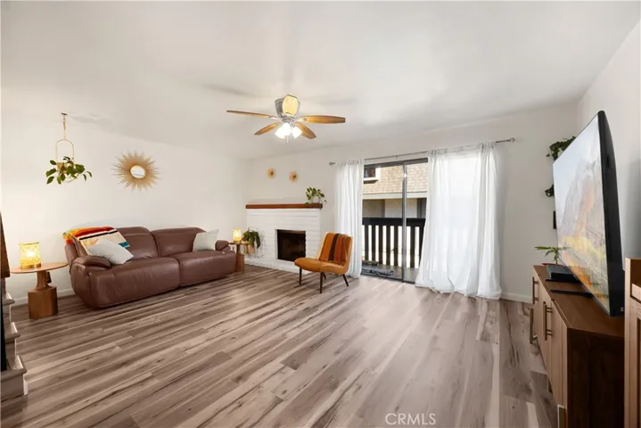 Spacious living room with fireplace and sliding glass door onto private Patio.